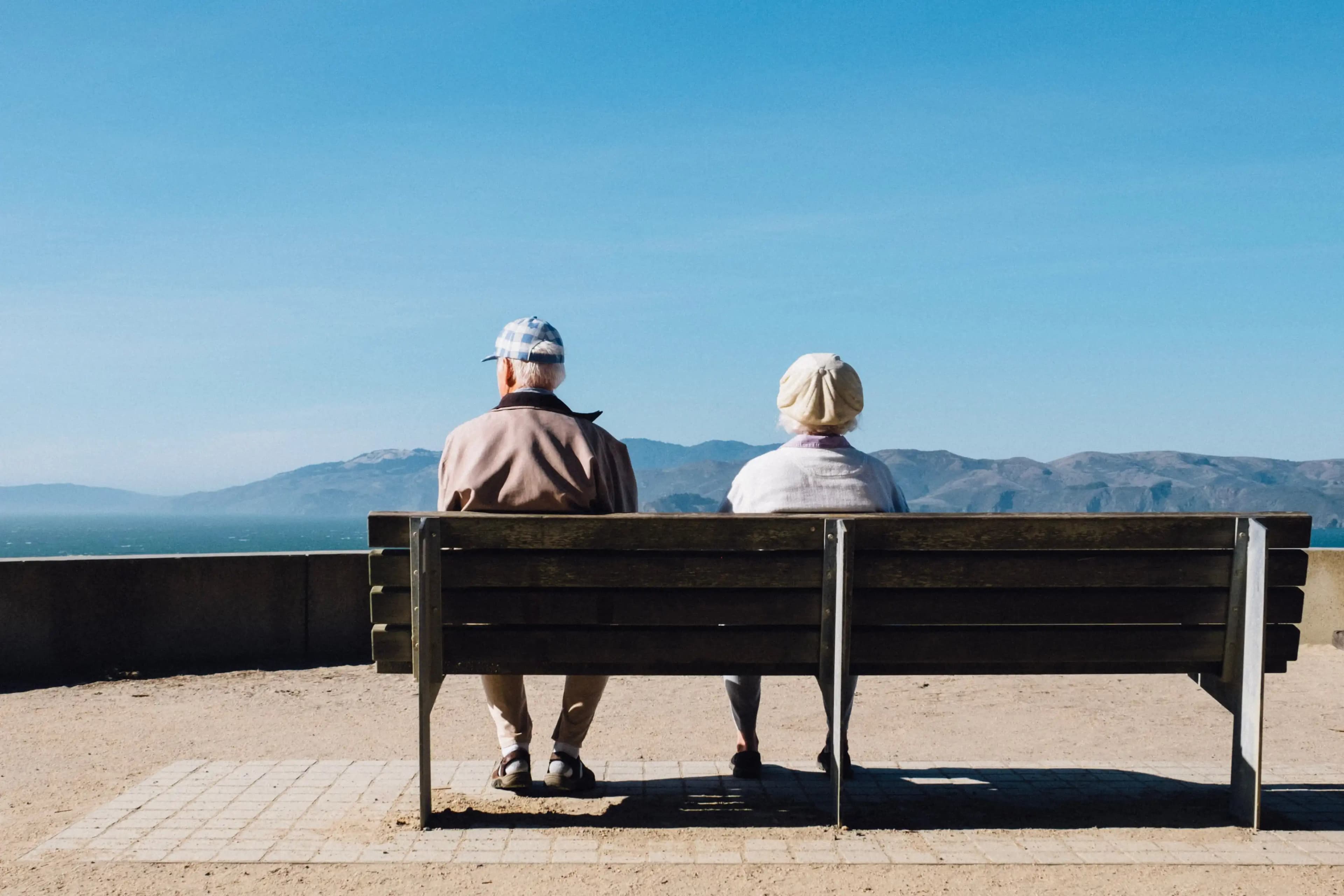 Couple sitting together on a bench.